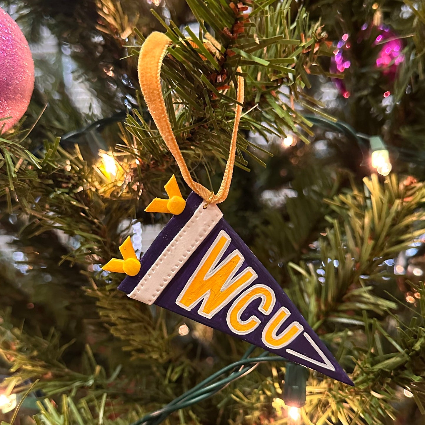 Decorative ornament with 'WCU' on a Christmas tree