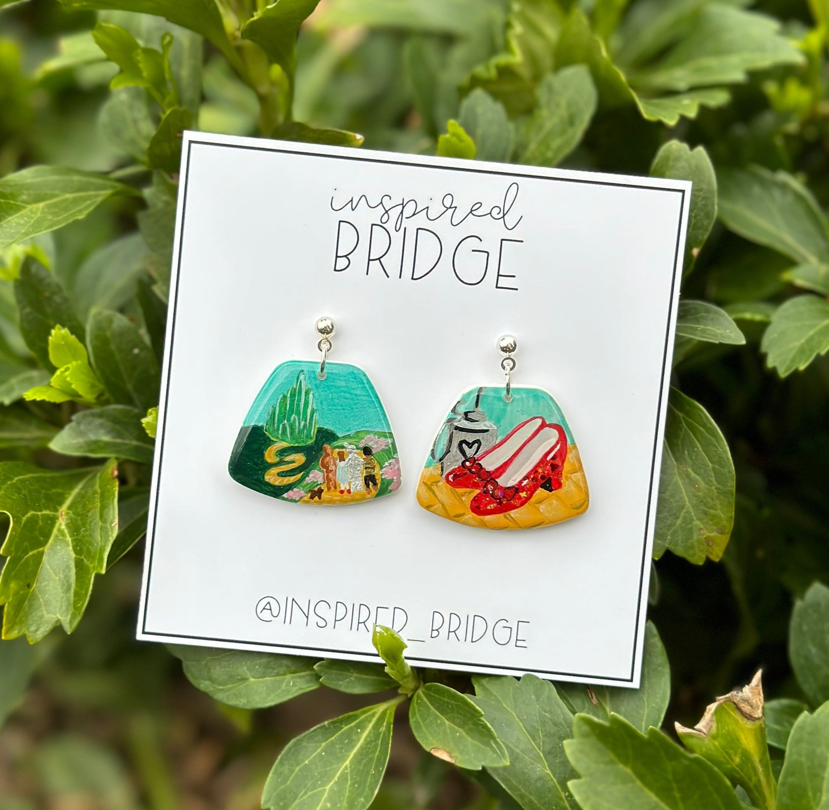 wizard of oz themed earrings featuring yellow brick road and red slippers